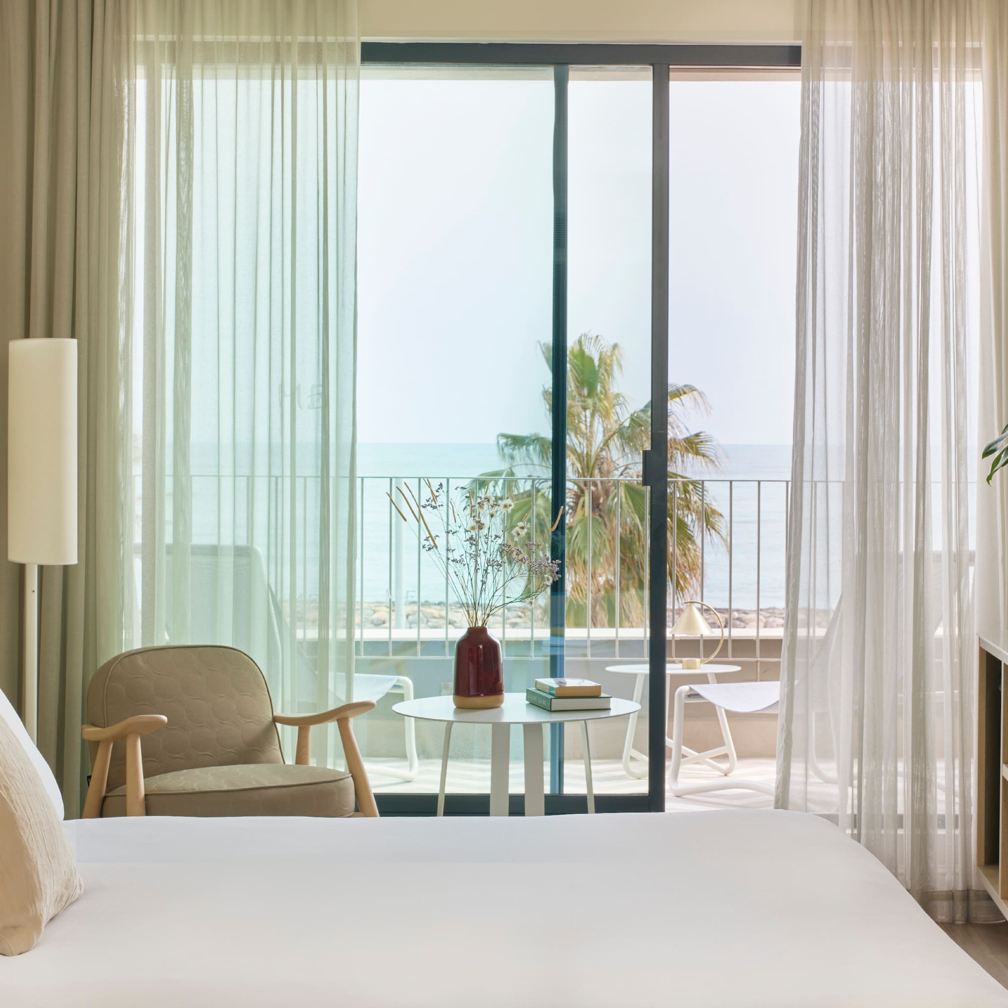 a bedroom with a window and a chair