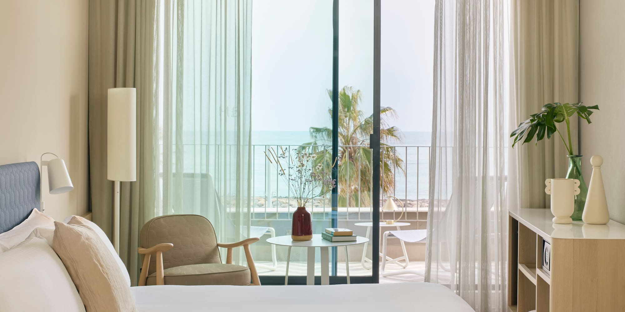 a bedroom with a window and a chair