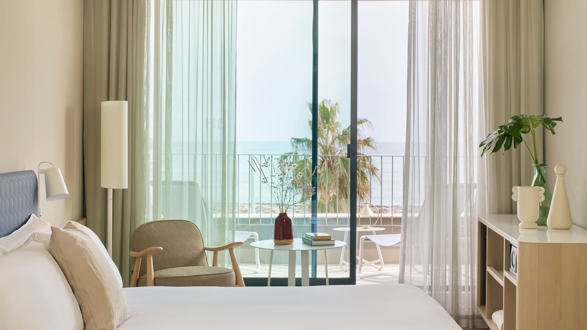 a bedroom with a window and a chair