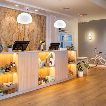 a reception desk with shelves and a bicycle