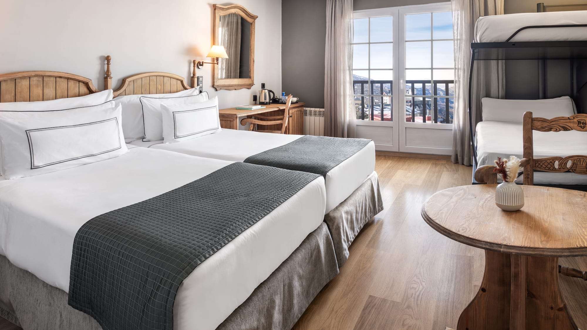 a room with two beds and a bunk bed