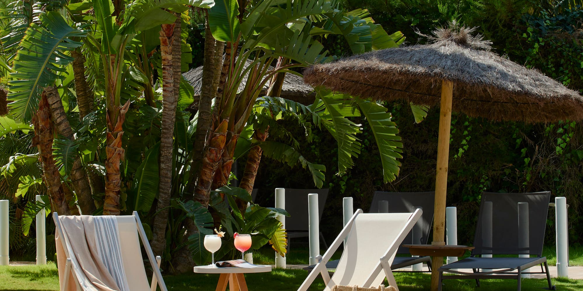 chairs and a table by a pool