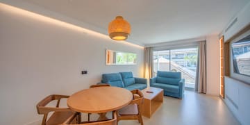 a living room with a table and chairs
