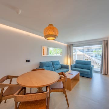 a living room with a table and chairs
