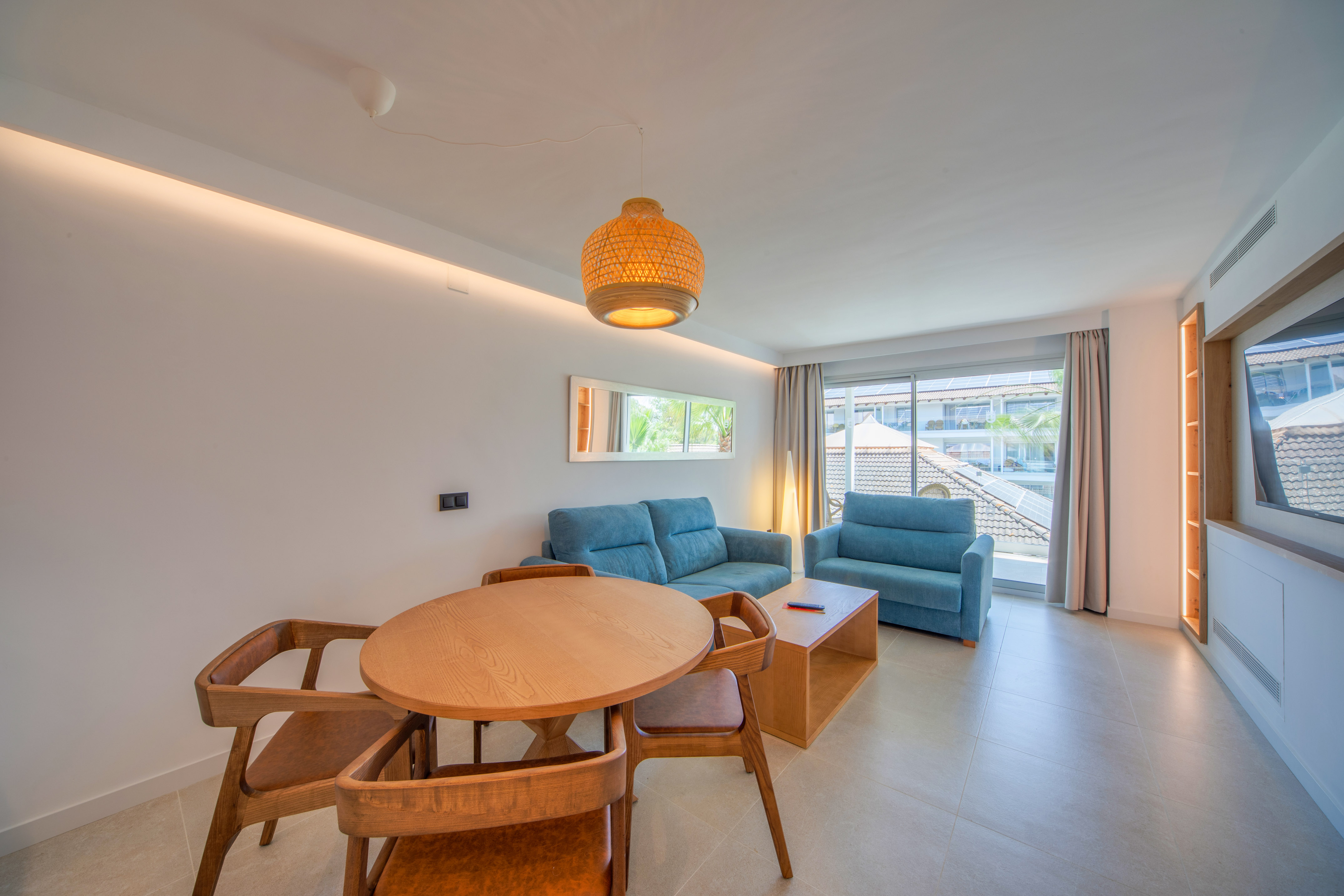 a living room with a table and chairs