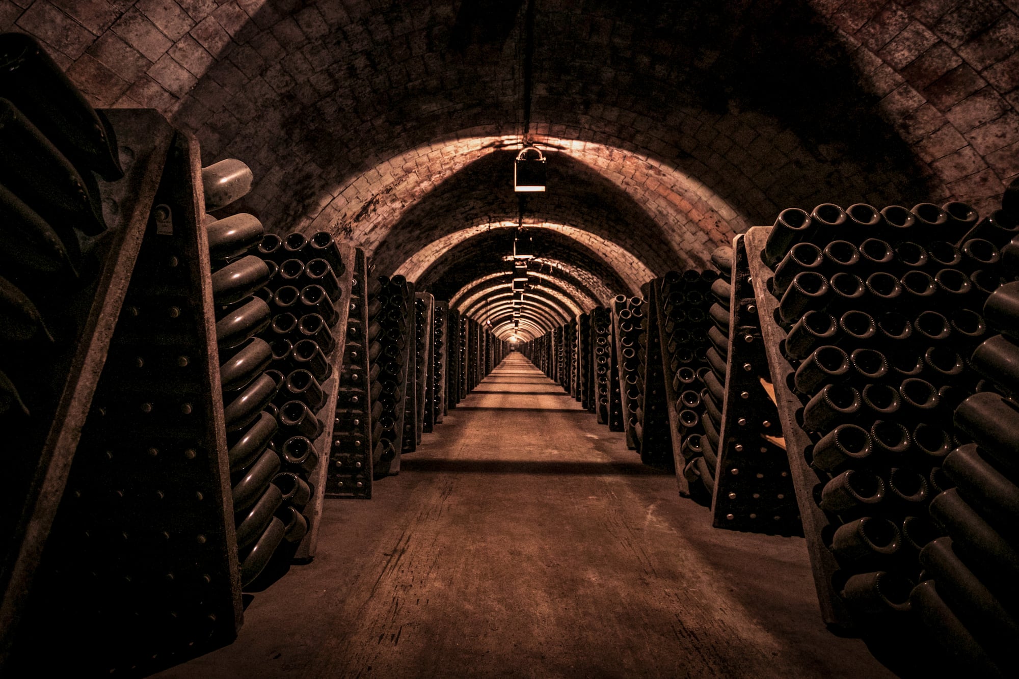 a tunnel with rows of wine bottles