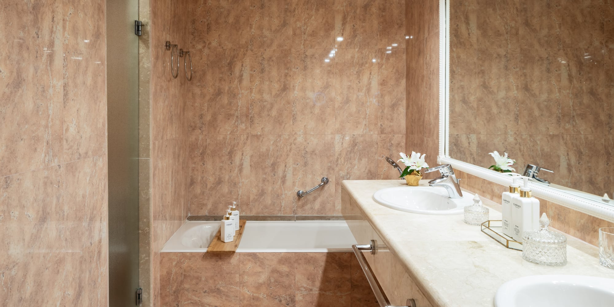 a bathroom with marble walls and a sink and bathtub
