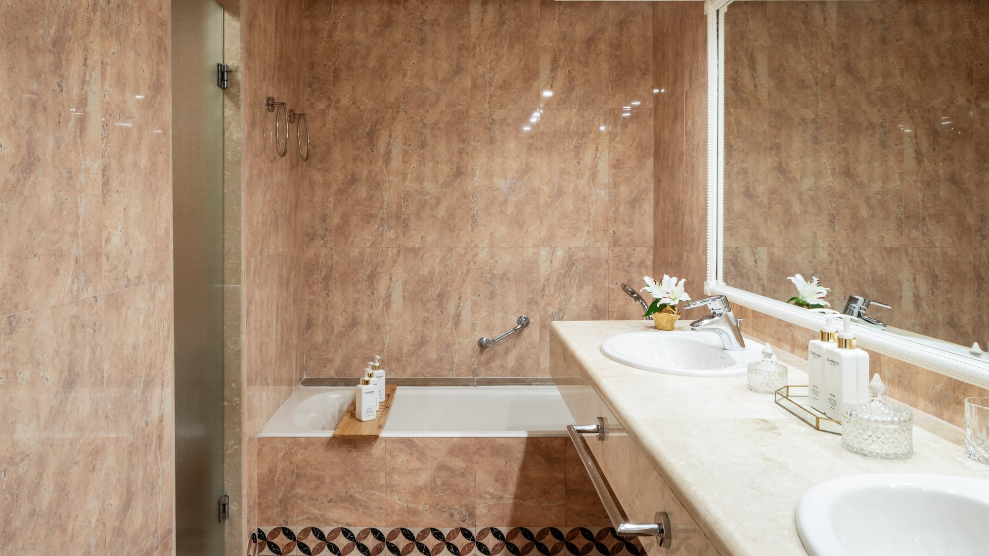 a bathroom with marble walls and a sink and bathtub