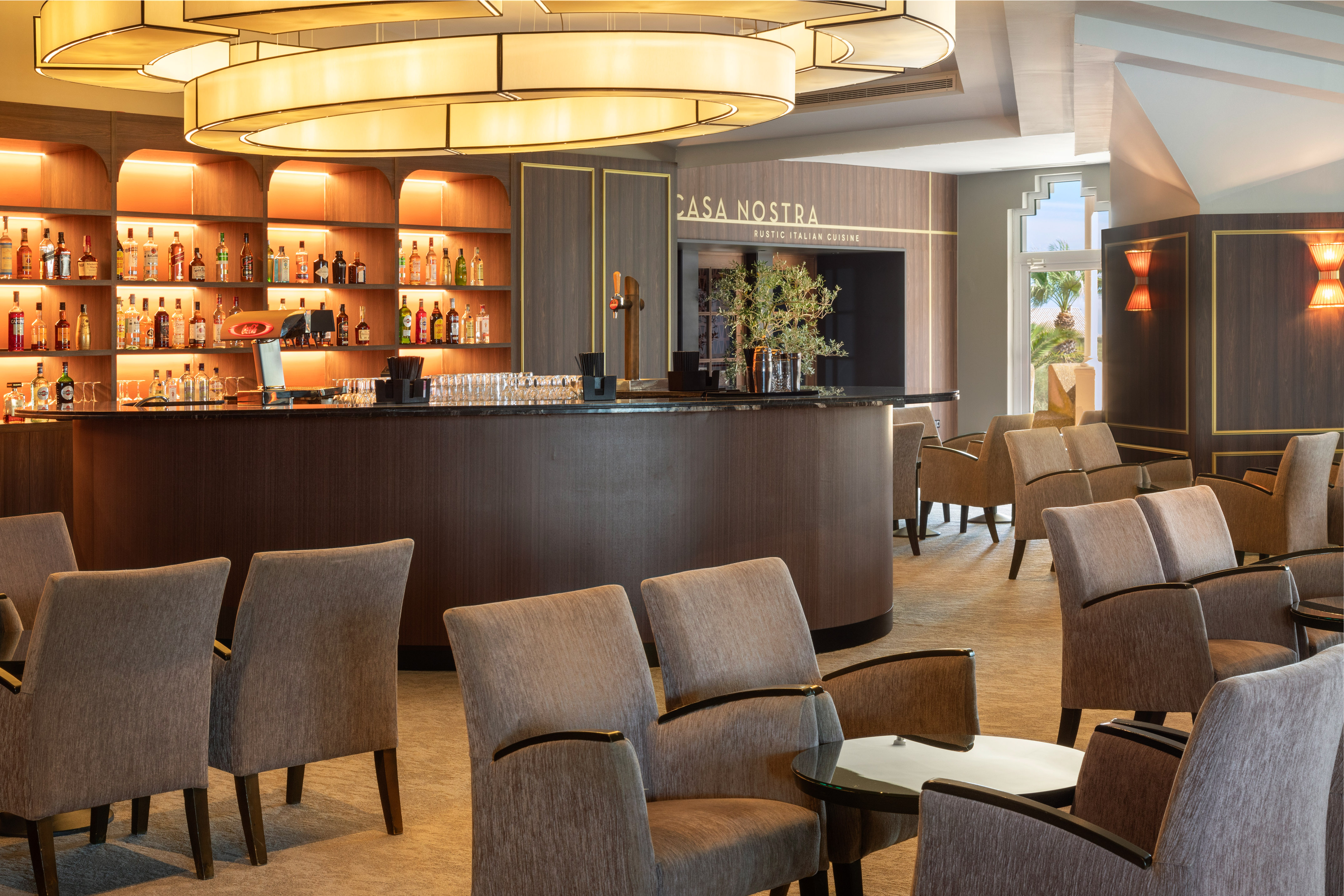 Rustic Italian Casa Nostra restaurant bar, stocked shelves, lounge seating.