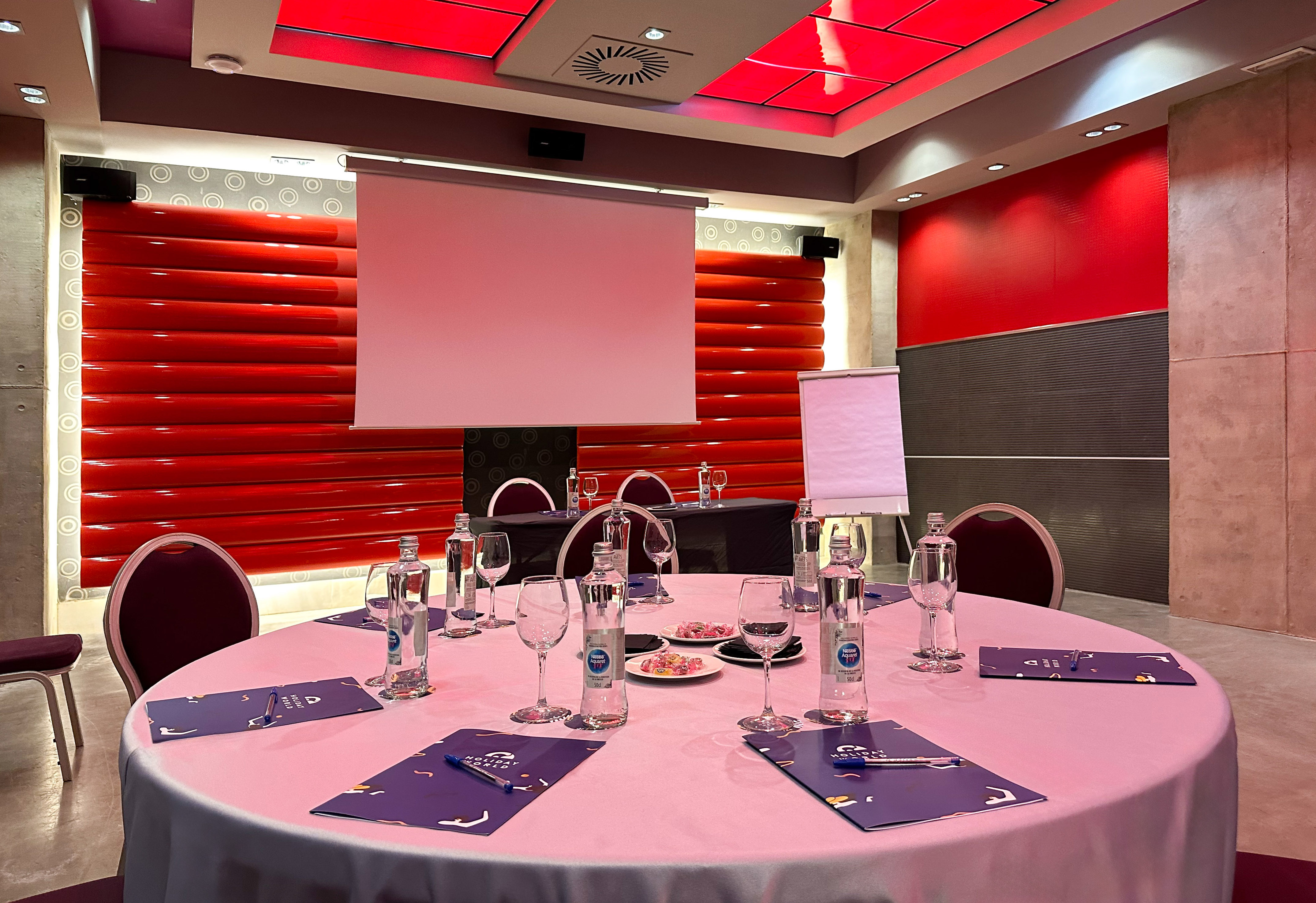 a round table with a pink tablecloth and glasses on it