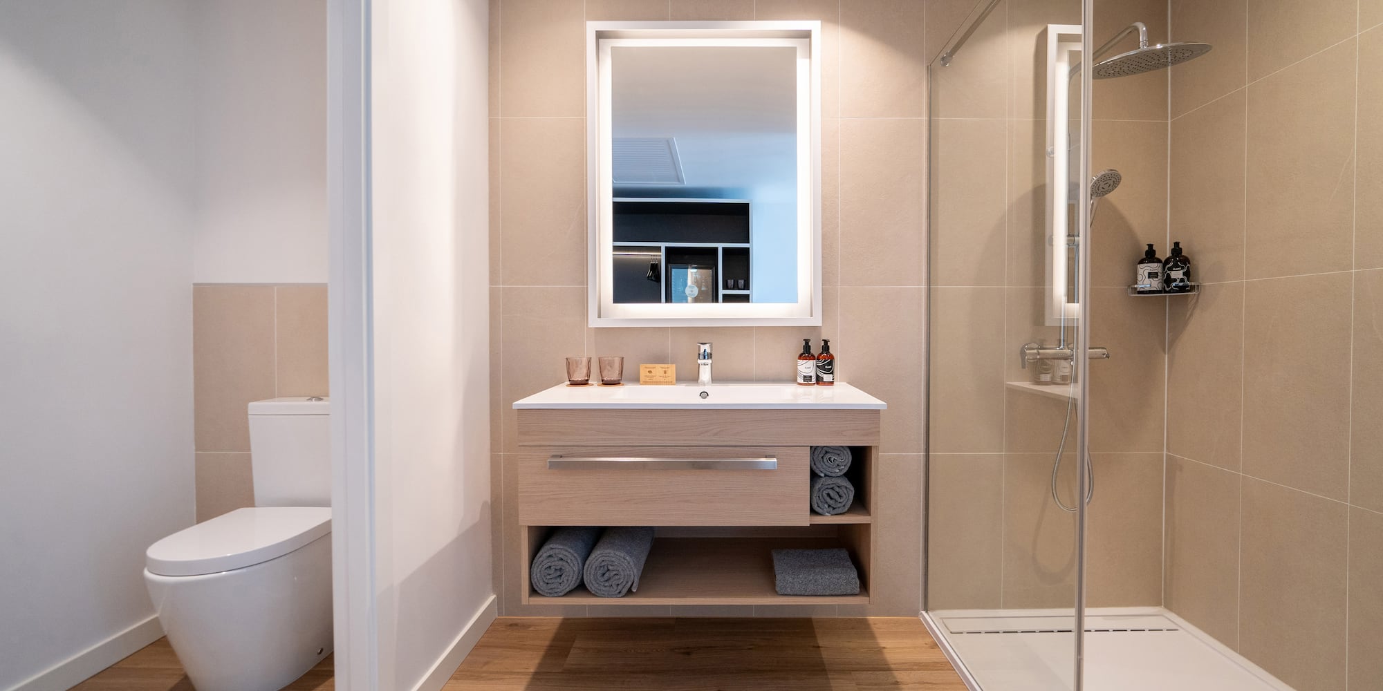 a bathroom with a mirror and a shower