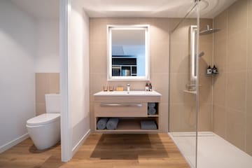 a bathroom with a mirror and a shower