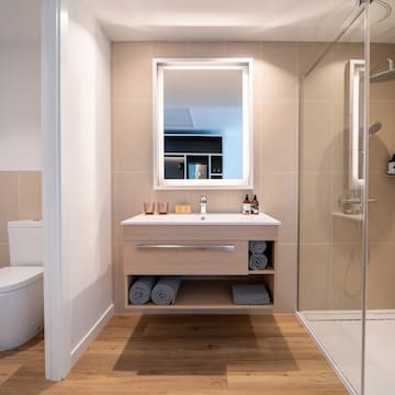 a bathroom with a mirror and a shower