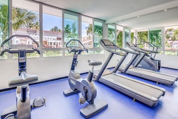 a room with exercise machines and windows