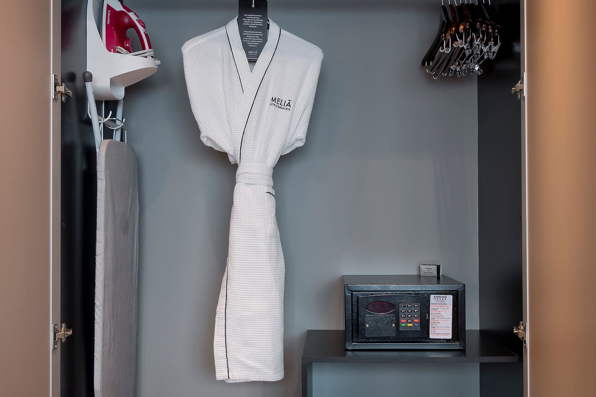 a closet with a white robe and irons