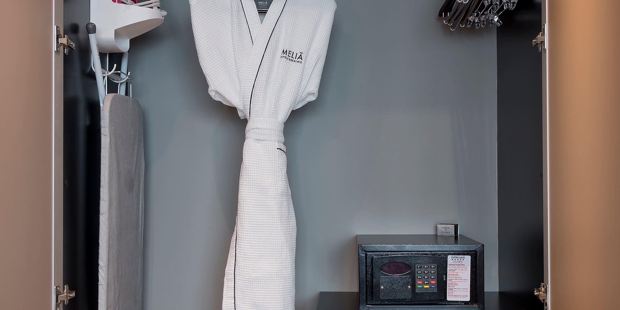 a closet with a white robe and irons