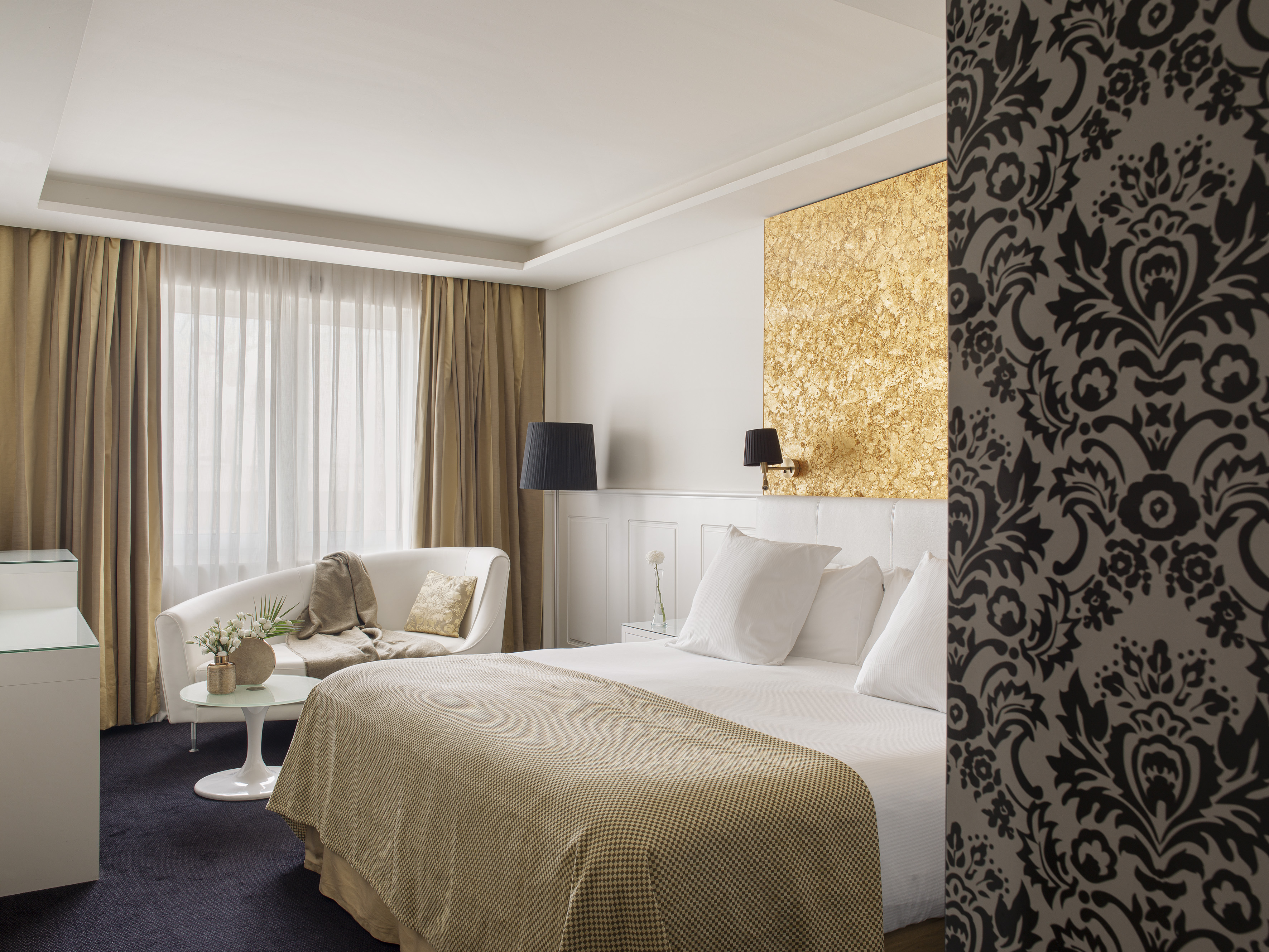 a room with a bed and a chair