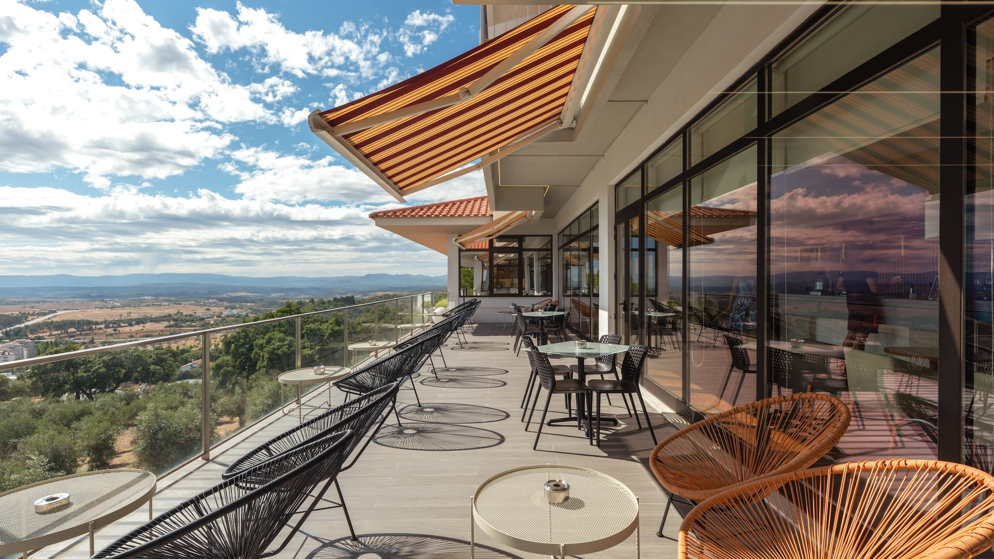 a patio with chairs and tables on a deck