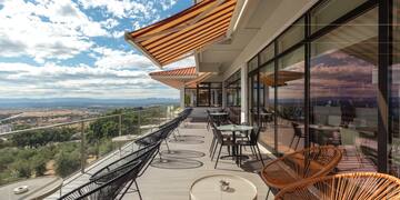 a patio with chairs and tables on a deck