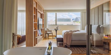 a room with a bed and a bathtub