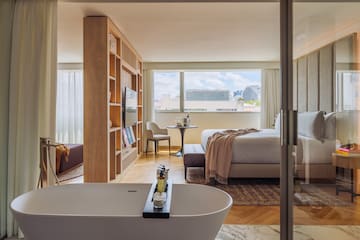 a room with a bed and a bathtub