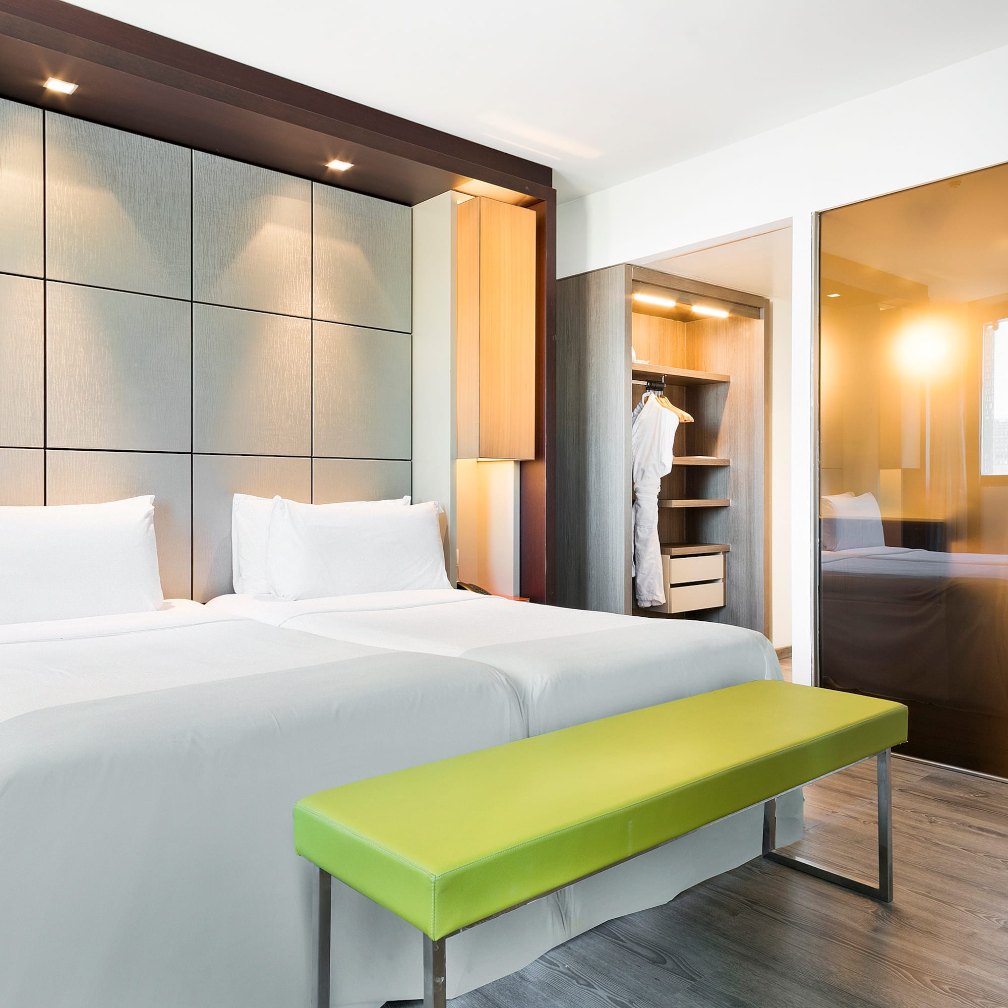 a room with a bed and a bench