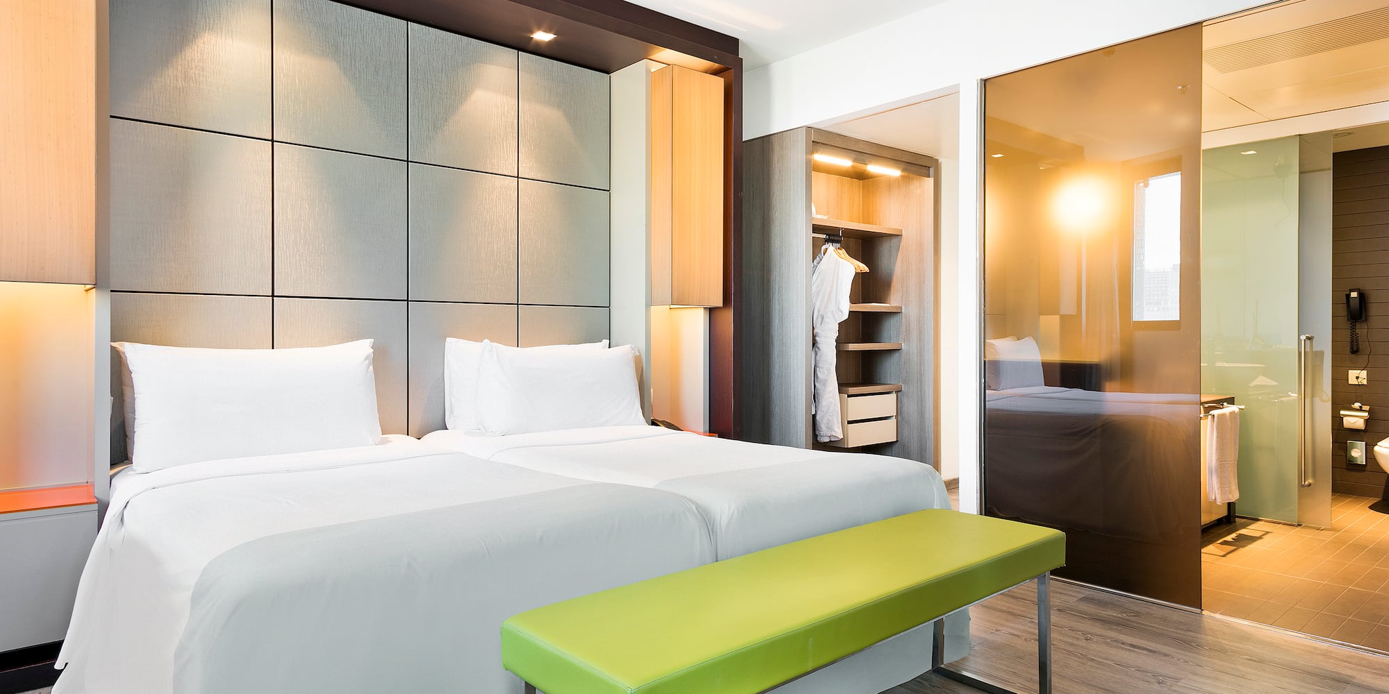 a room with a bed and a bench