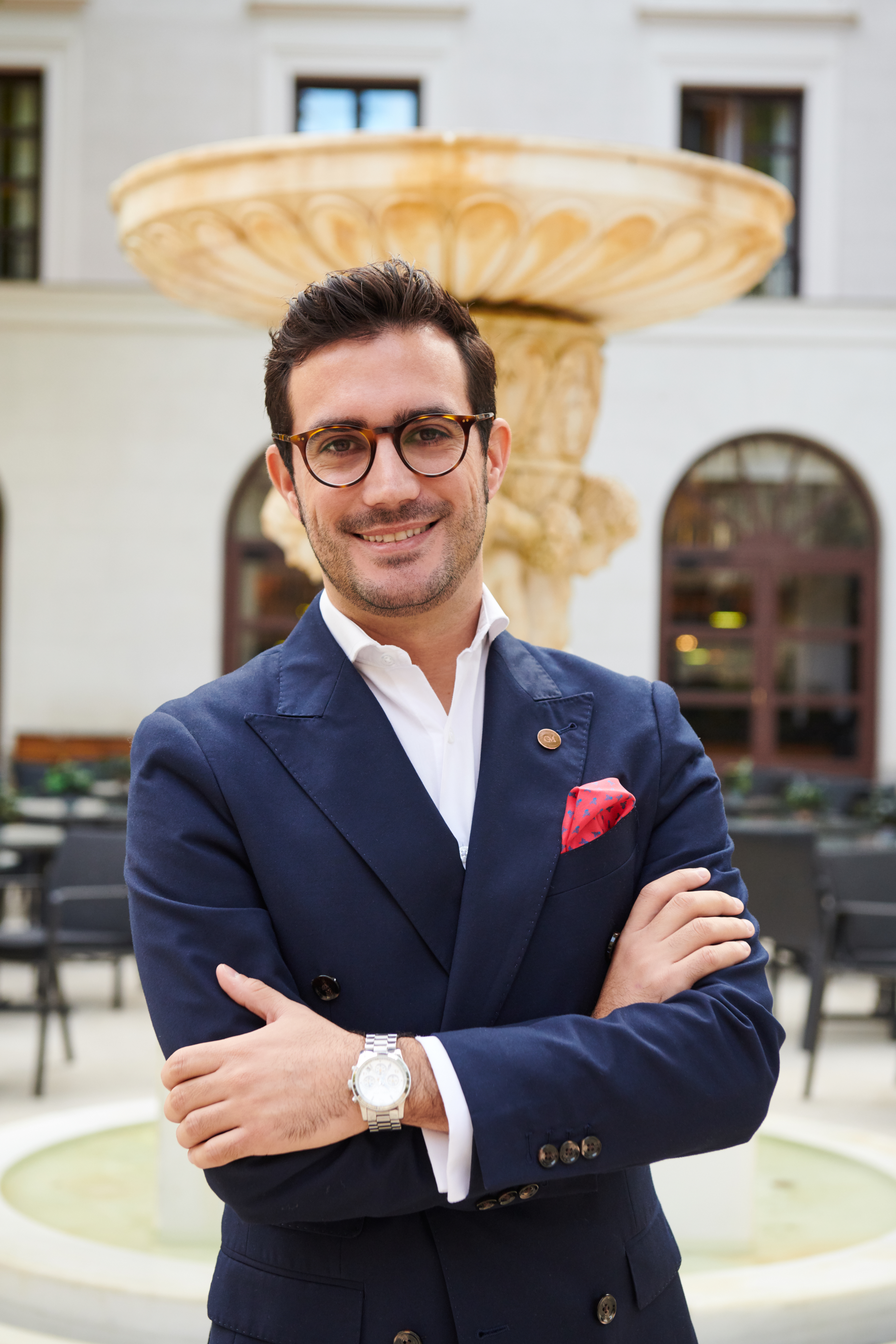 a man in a suit with his arms crossed