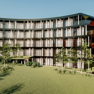 a building with trees and grass