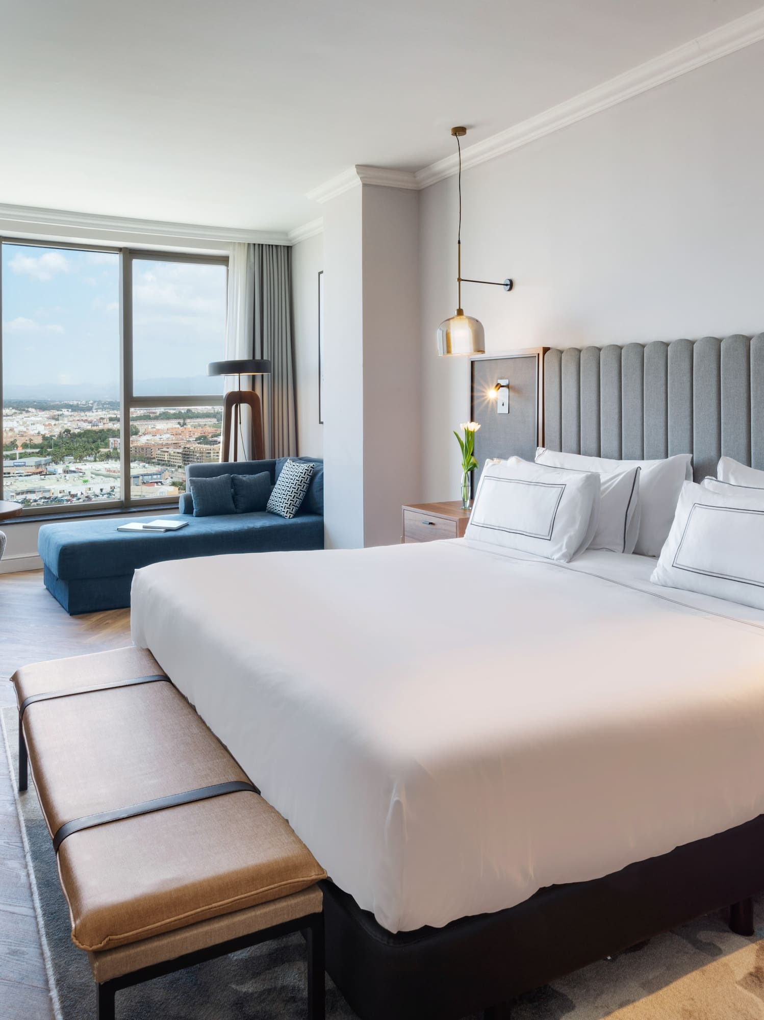 a bedroom with a large bed and a large window