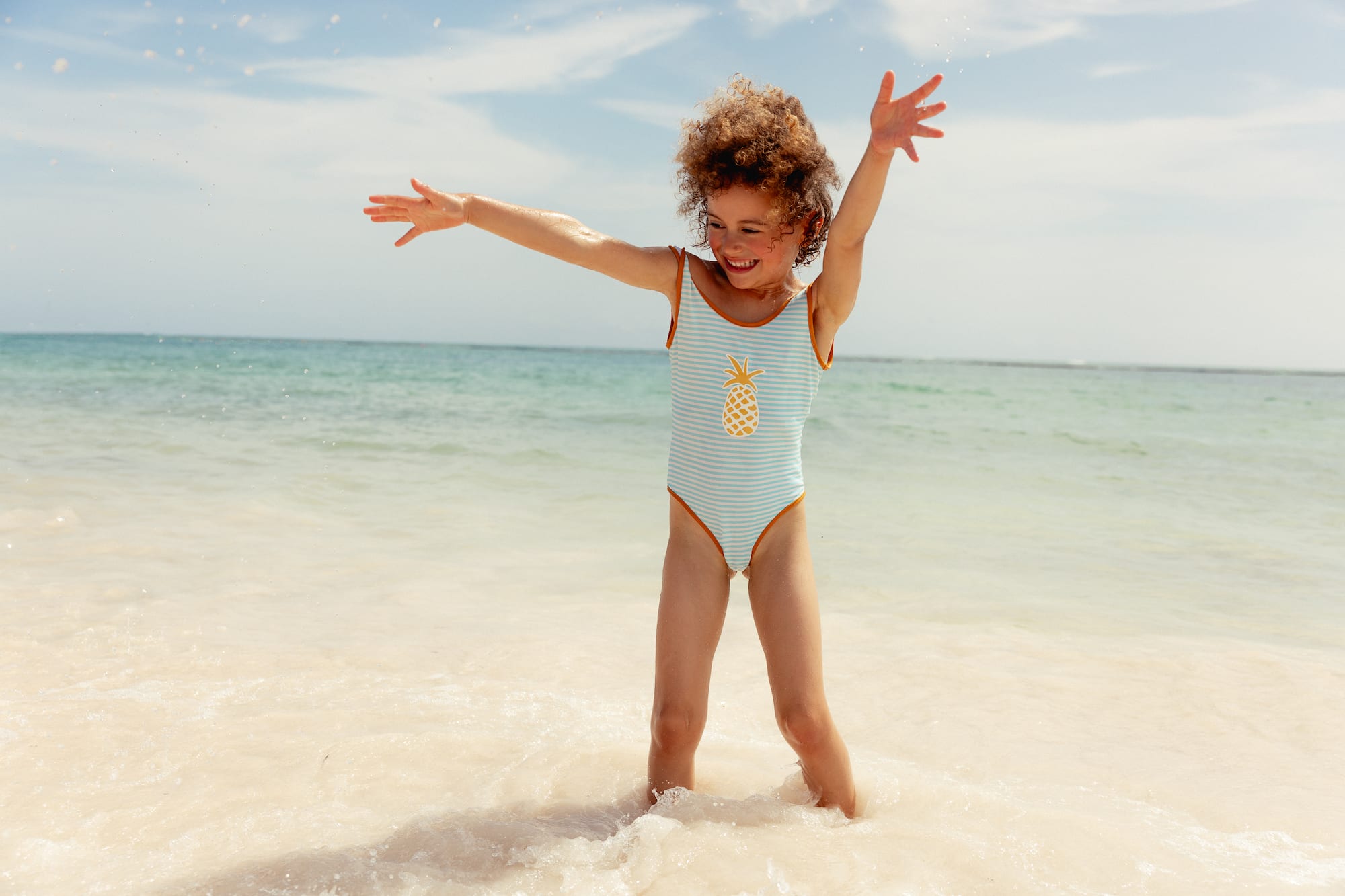 a girl in a swimsuit on a beach