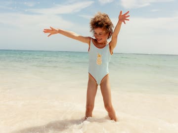 a girl in a swimsuit on a beach