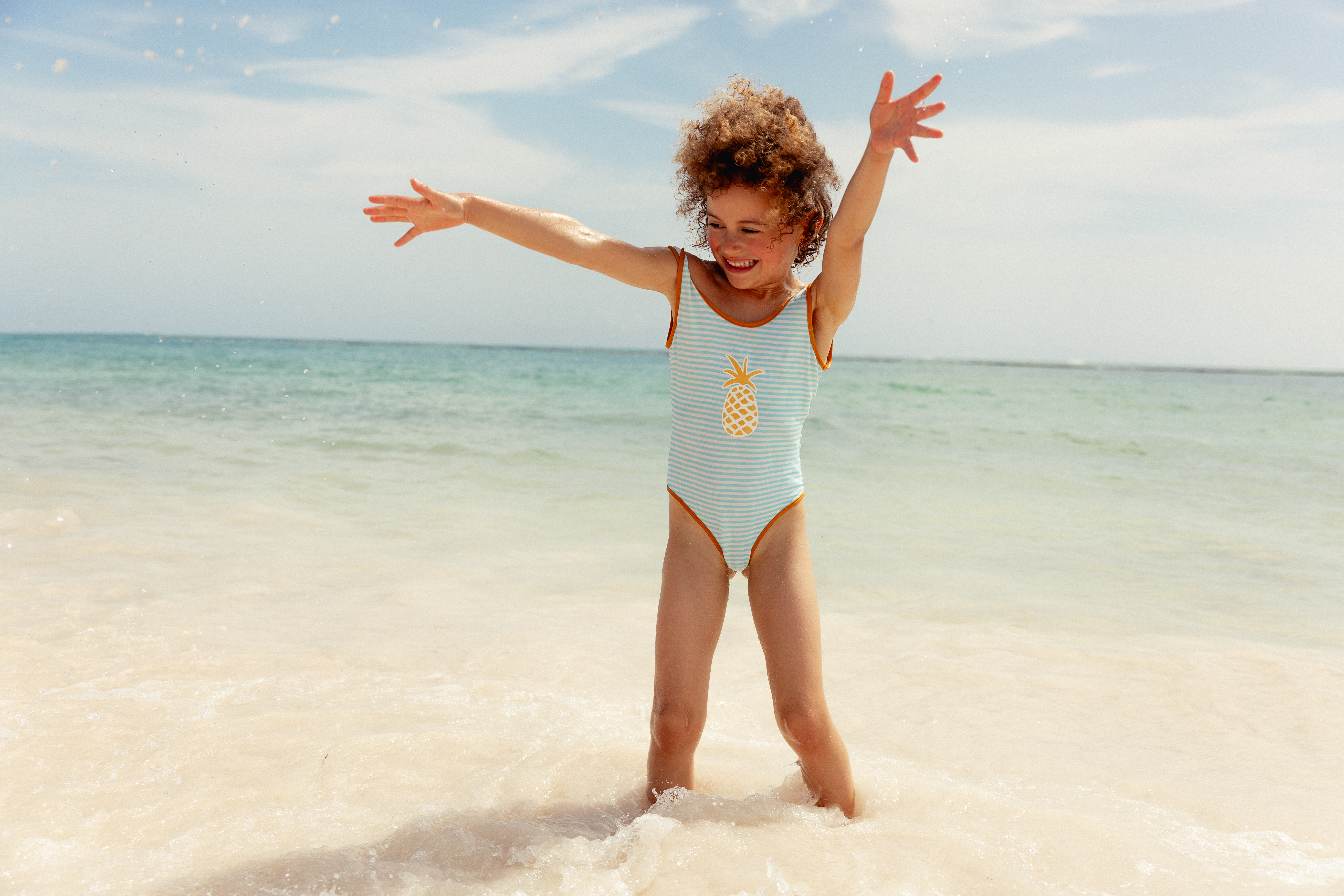 a girl in a swimsuit on a beach
