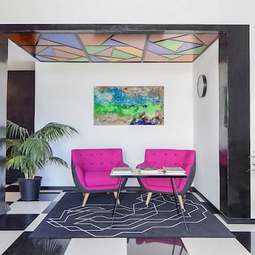 a room with pink chairs and a table