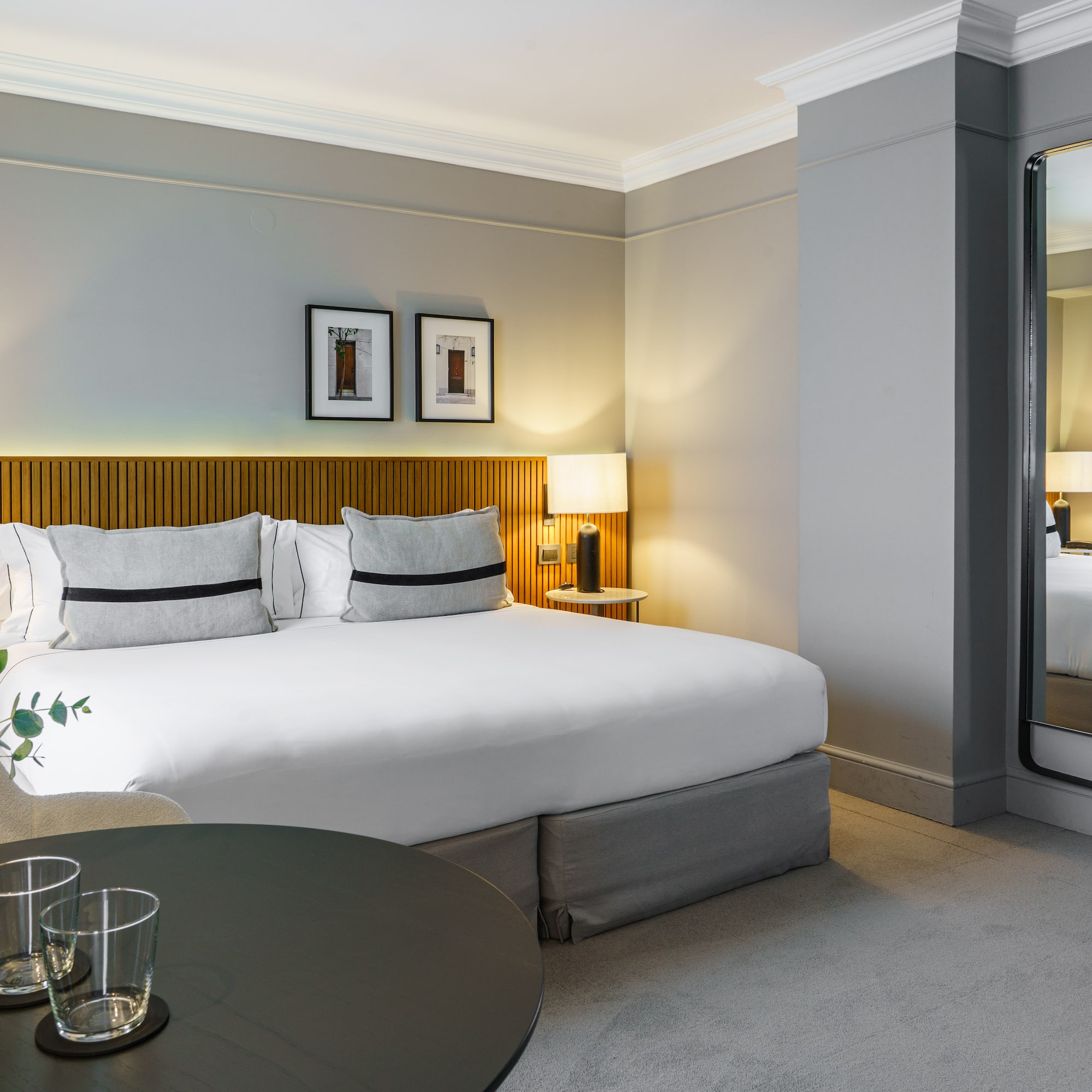 a bedroom with a mirror and a bed