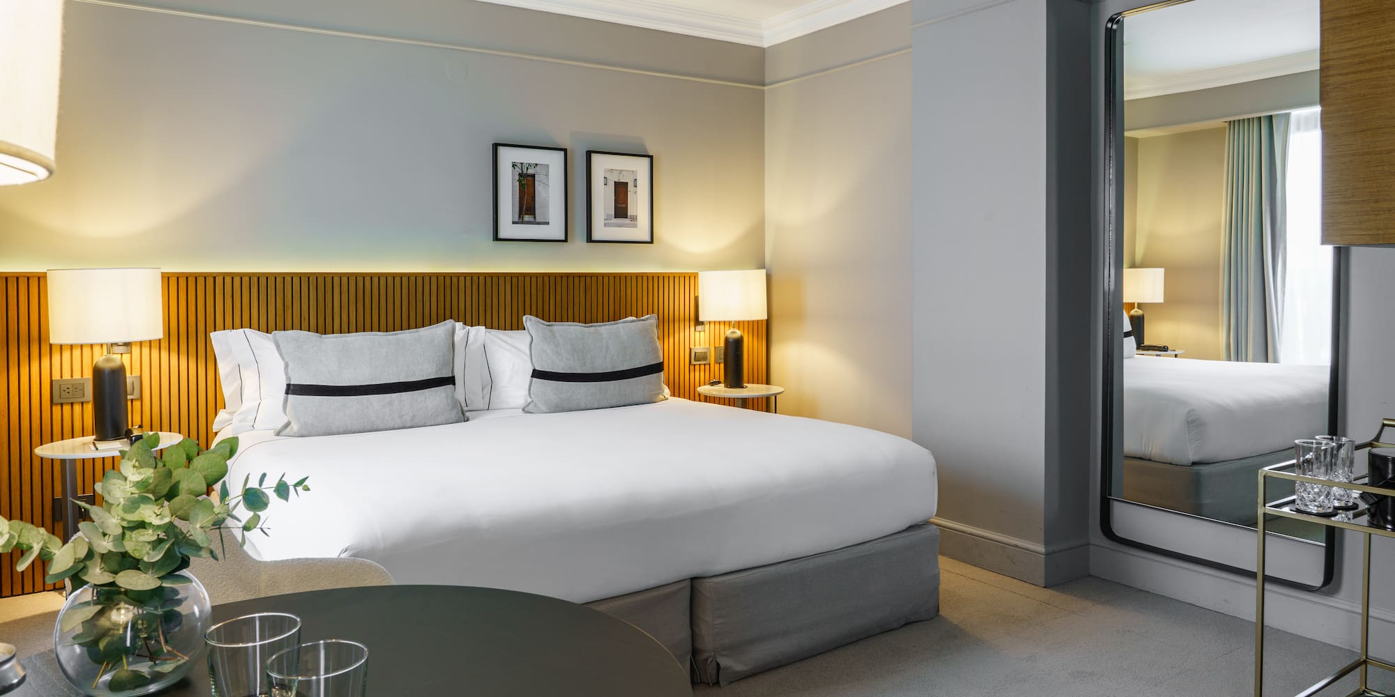 a bedroom with a mirror and a bed