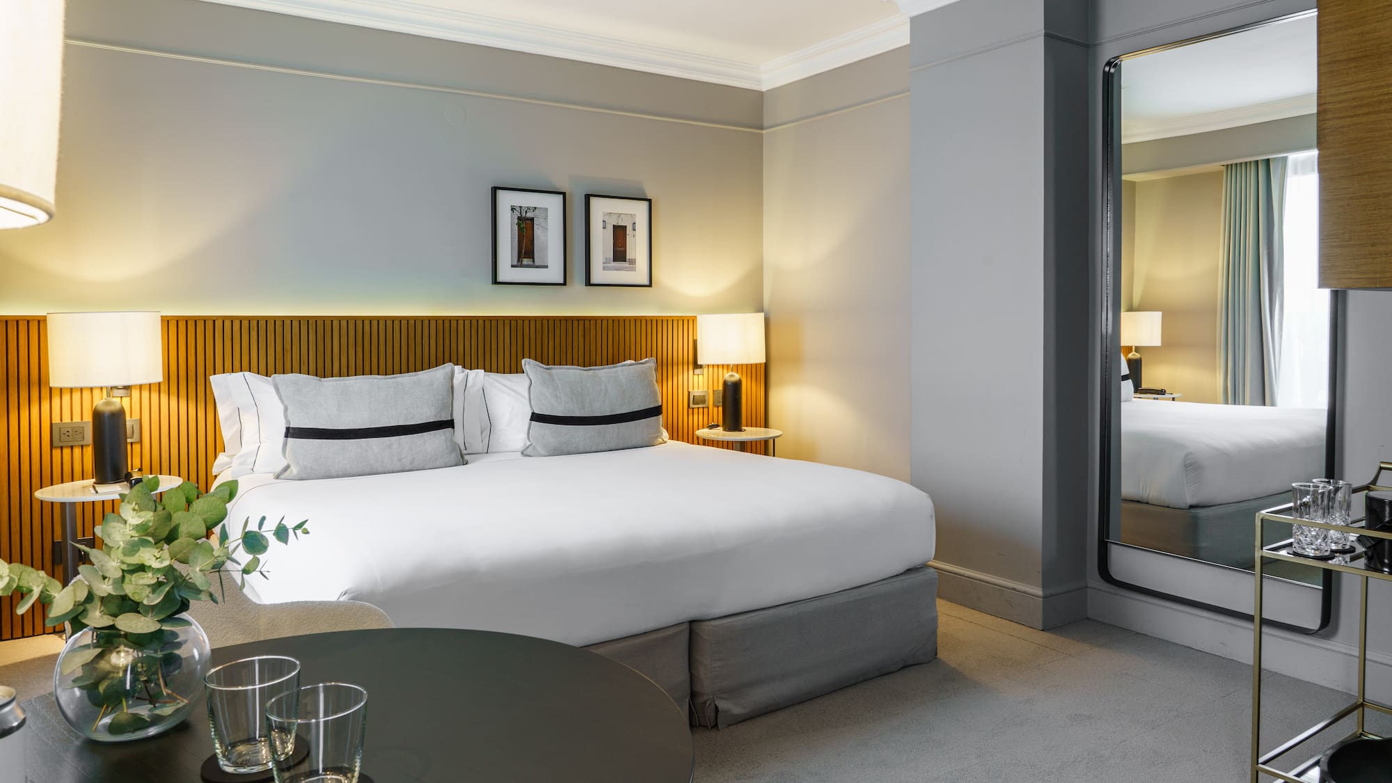 a bedroom with a mirror and a bed