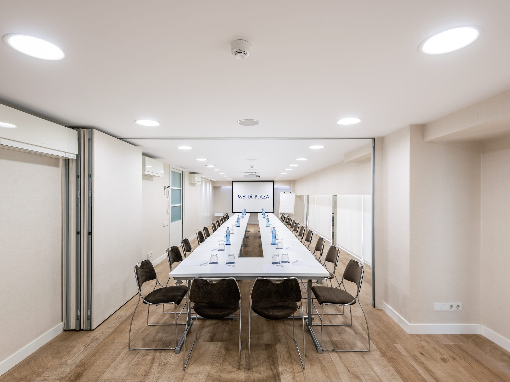 a room with a long table and chairs.