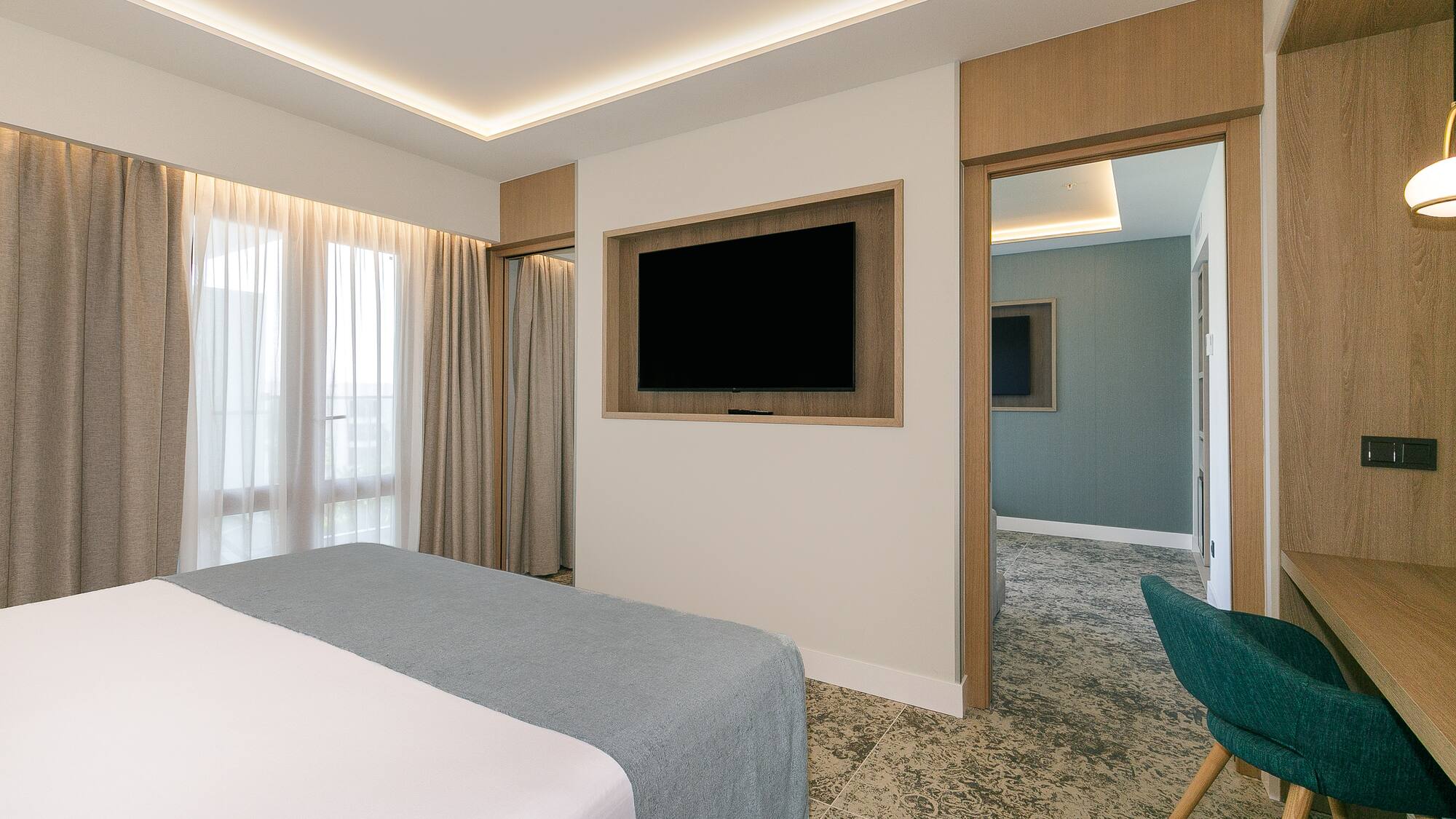 a room with a bed and a tv