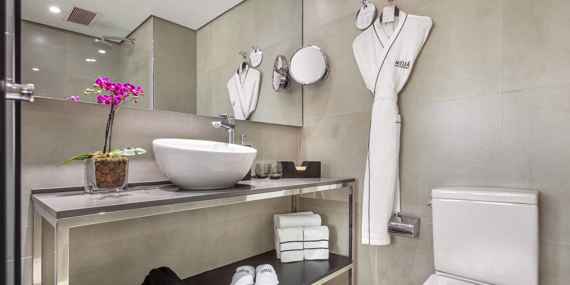 a bathroom with a sink and a towel on the wall