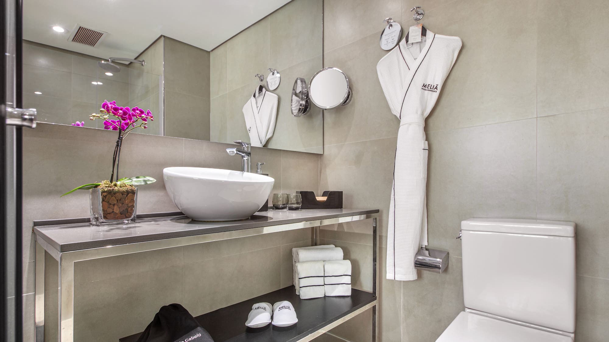 a bathroom with a sink and a towel on the wall