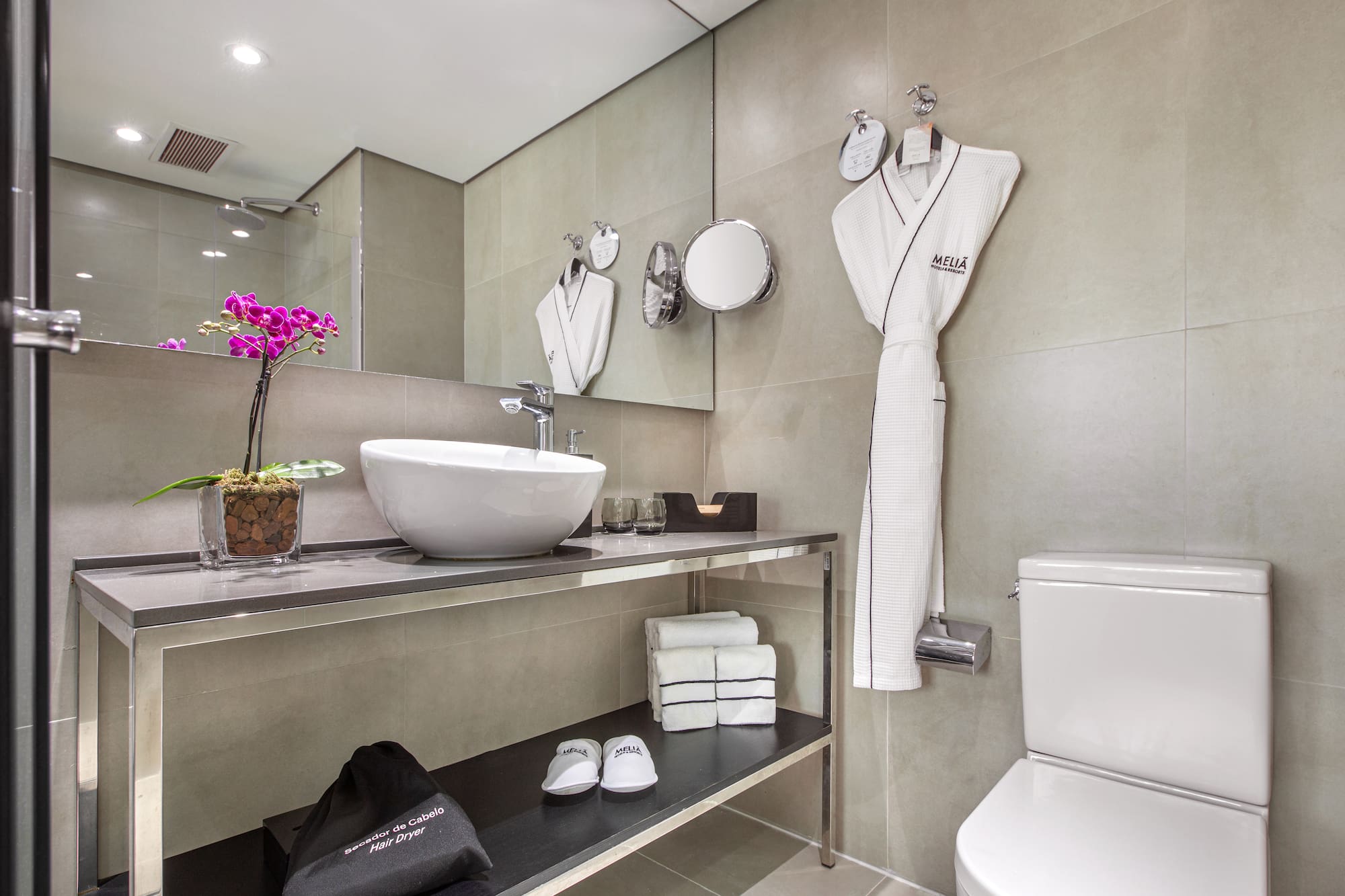 a bathroom with a sink and a towel on the wall