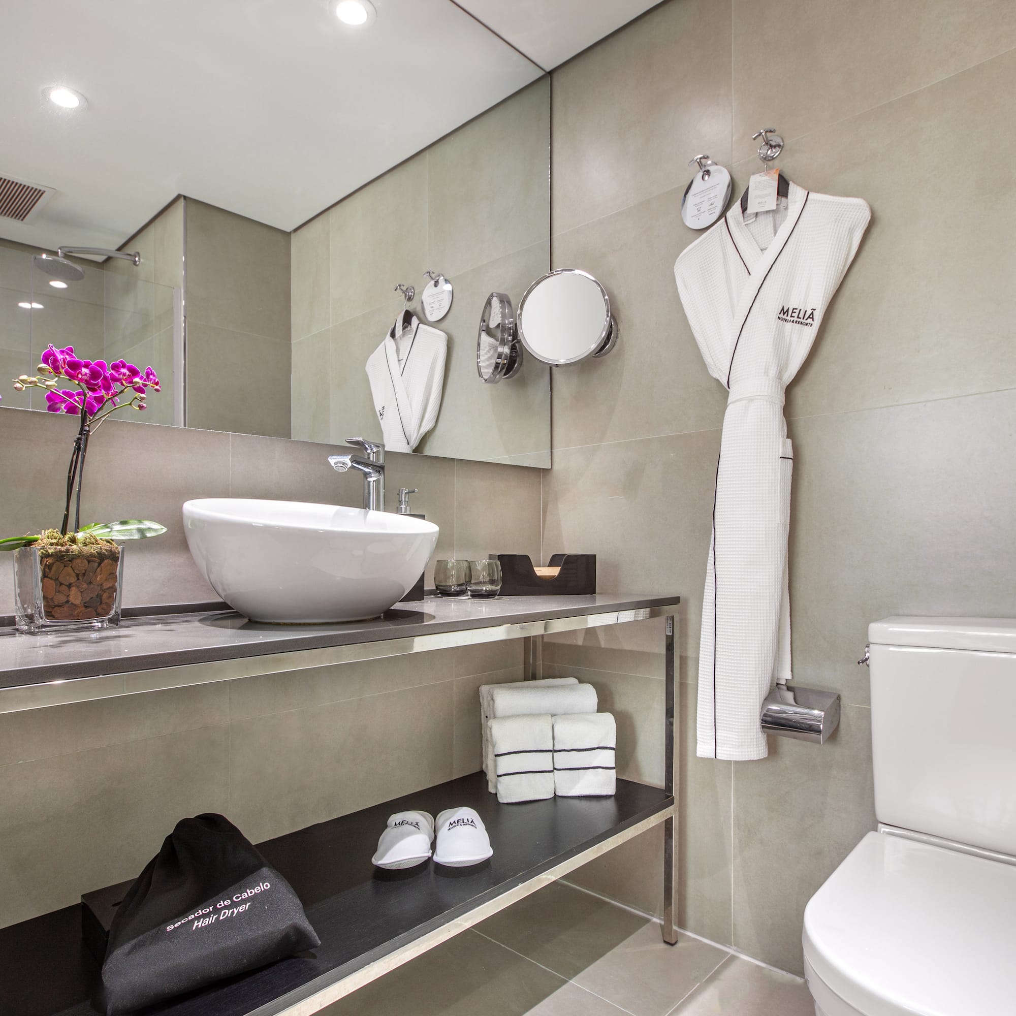 a bathroom with a sink and a towel on the wall