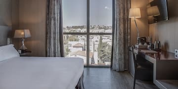 a bedroom with a desk and a lamp