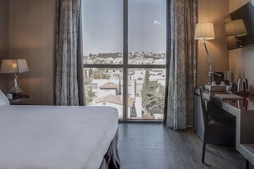 a bedroom with a desk and a lamp