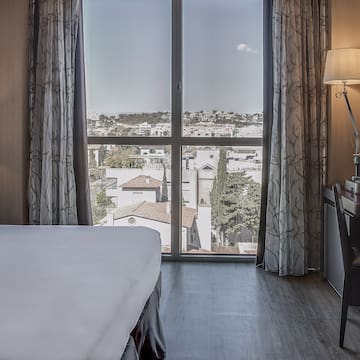 a bedroom with a desk and a lamp