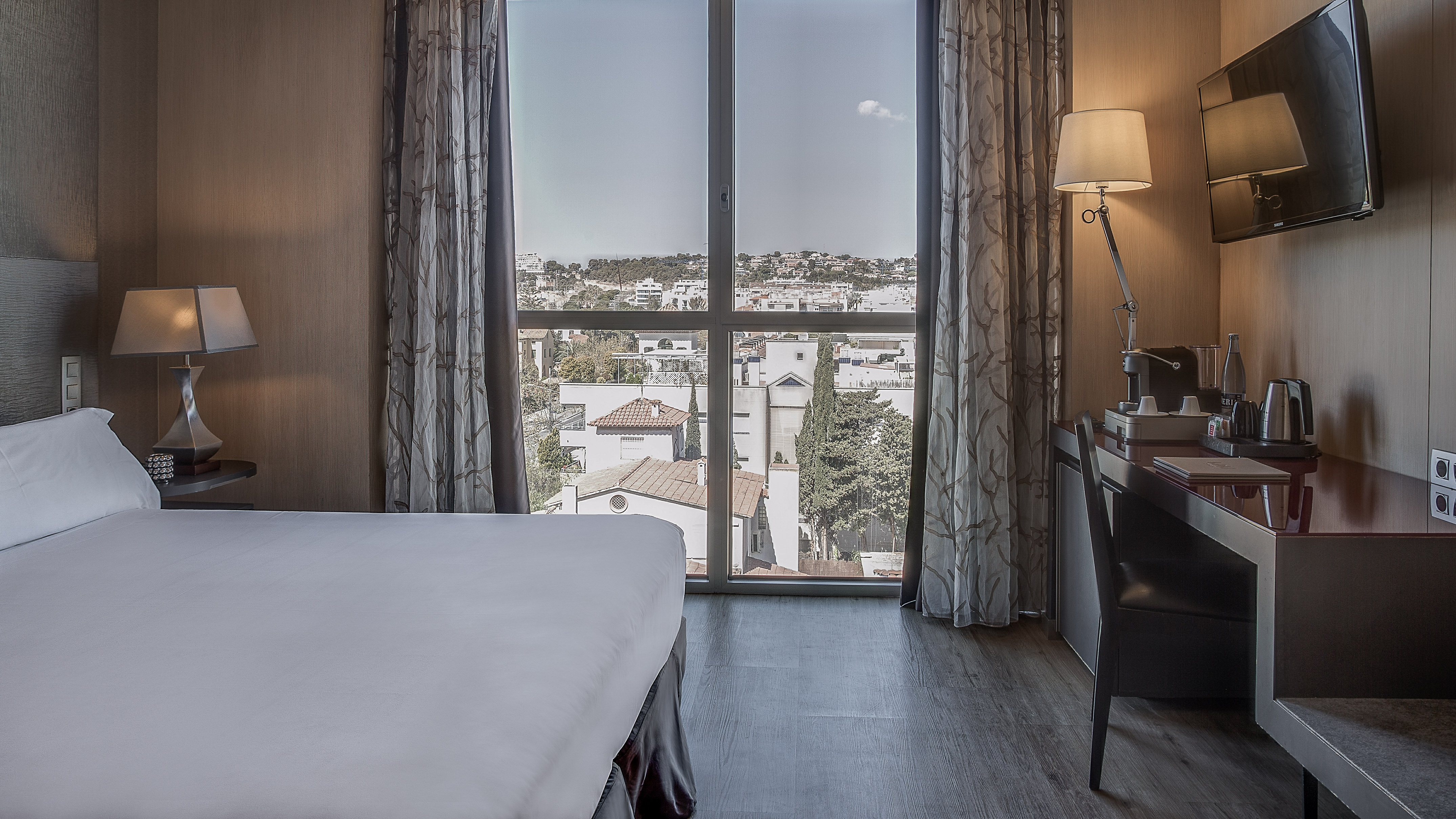 a bedroom with a desk and a lamp