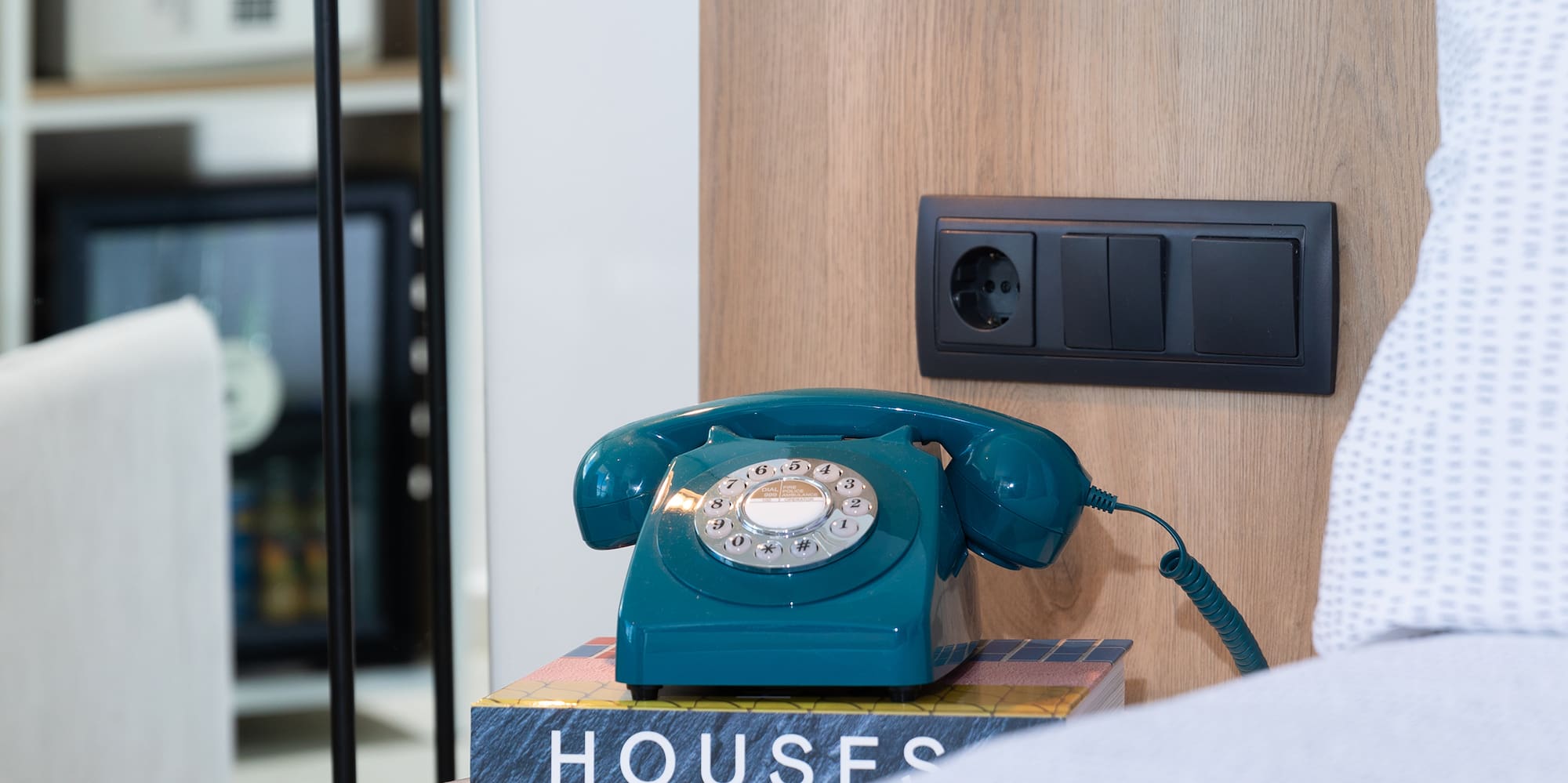 a telephone on a book on a nightstand