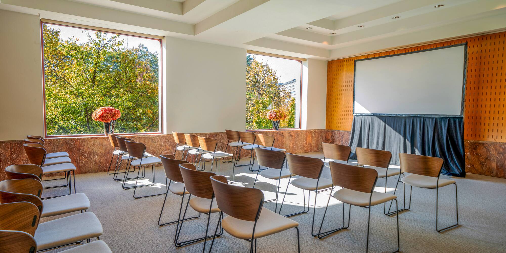 a room with chairs and a white board