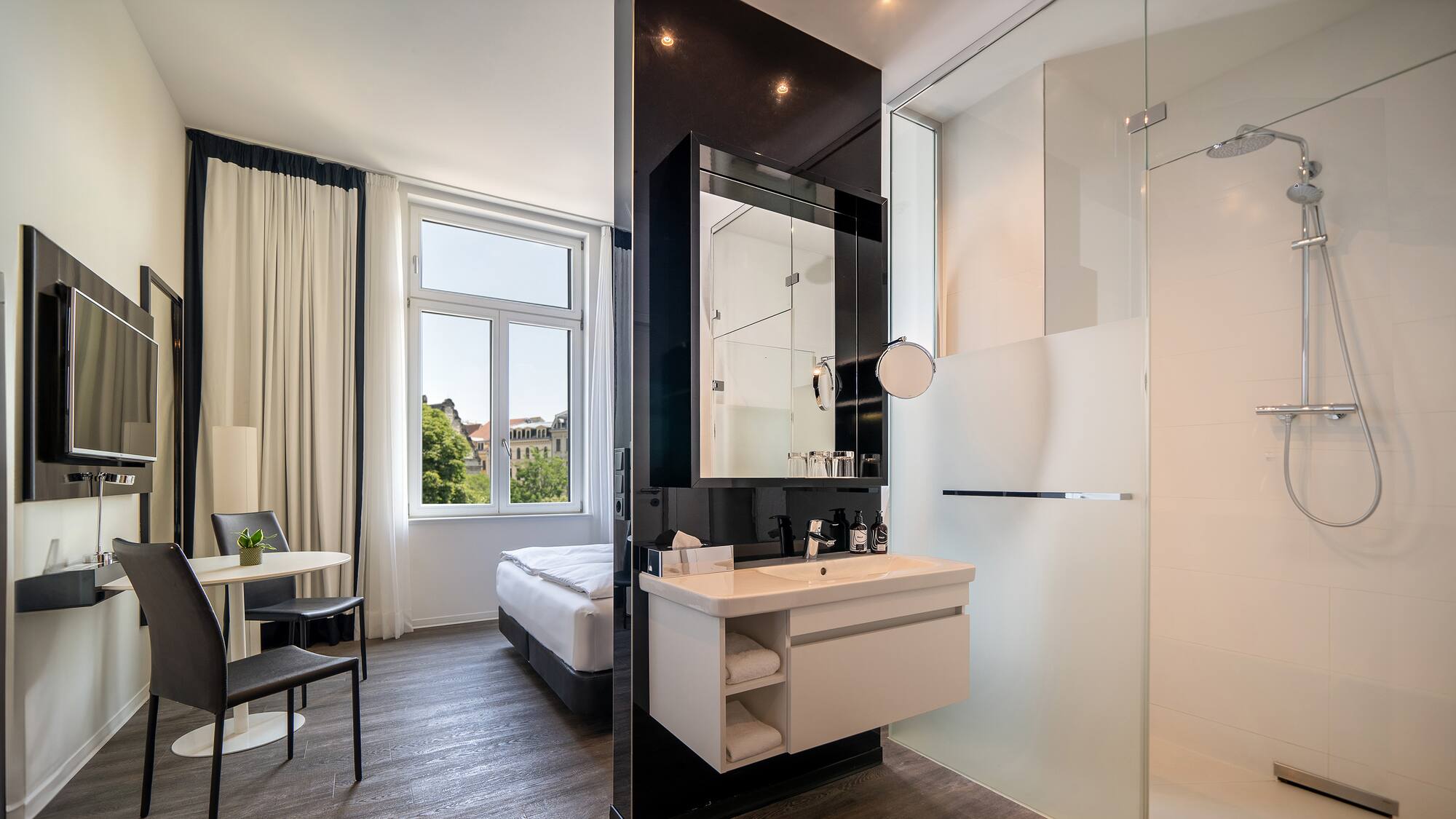 a bathroom with a shower and a bed